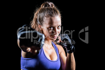 Portrait of female fighter punching