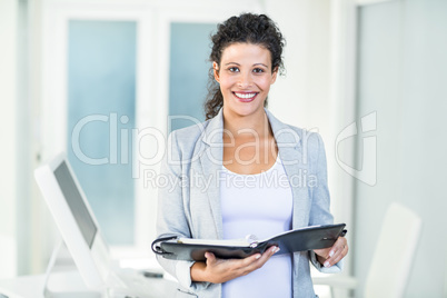 Smiling beautiful businesswoman holding document