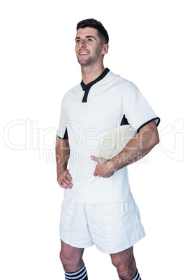 Cheerful rugby player holding ball