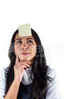 Woman thinking with a post it on her head