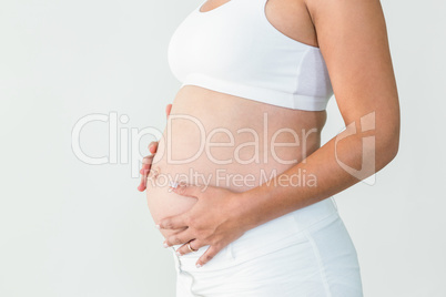 Pregnant woman touching stomach