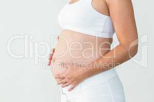 Pregnant woman touching stomach