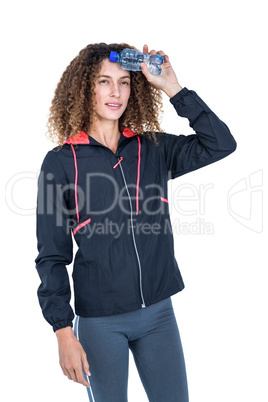 Thoughtful young woman holding water bottle