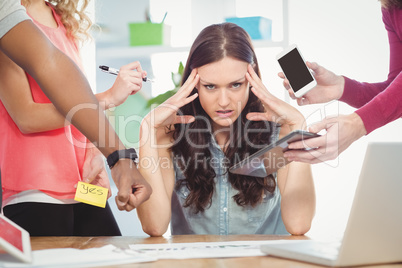 Portrait of depressed businesswoman with head in hands