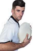 Portrait of rugby player posing with the ball