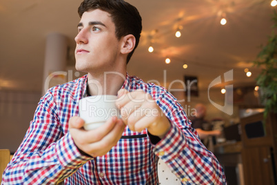 Young man holding coffee cup