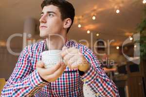 Young man holding coffee cup