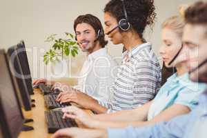 Portrait of smiling executive in call center