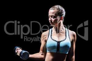 Sporty woman exercising with dumbbell