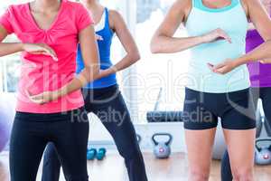 Midsection of women doing exercise