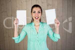 Portrait of woman making face and holding papers