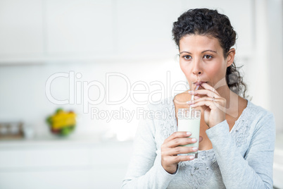 Pregnant woman drinking a glass of milk