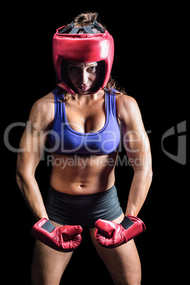 Portrait of female boxer flexing muscles