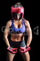 Portrait of female boxer flexing muscles