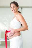 Portrait of happy woman with red ribbon