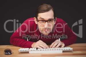 Portrait of concentrated man working on computer