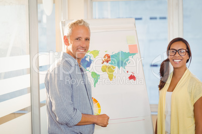 Happy business people with world map in meeting room