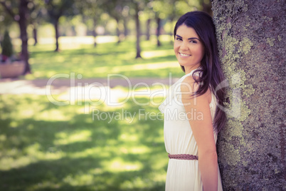 Portrait of cheerful woman leaning on tree Portrait of cheerful woman leaning on tree
