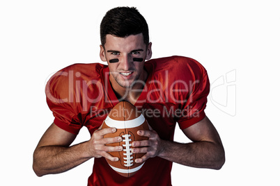 Portrait of serious player holding rugby ball