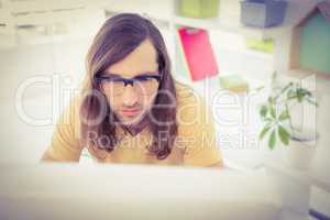 Hipster working at desk in office