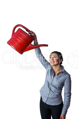 Happy woman holding a watering can over her head