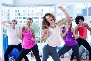 Portrait of women exercising with clasped hands