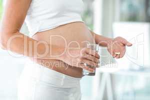 Midsection of woman with pills