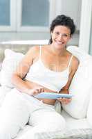 Portrait of happy woman using tablet
