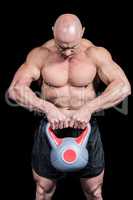 Muscular fit man lifting kettlebell