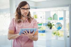 Confident hipster using digital tablet