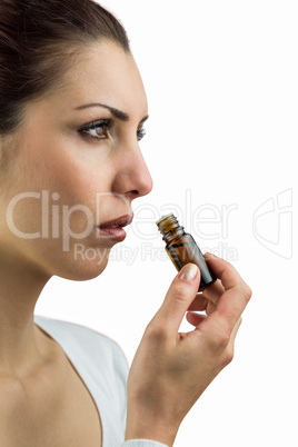 Close-up of woman holding bottle of medicine