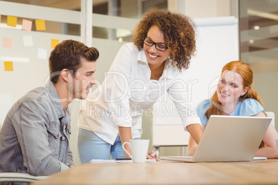 Female colleagues looking at businessman