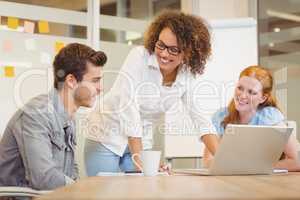 Female colleagues looking at businessman