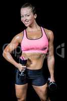 Portrait of happy woman with dumbbells