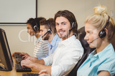 Portrait of smiling executive in call center