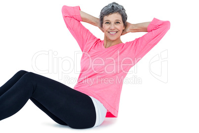 Portrait of mature woman doing sit ups