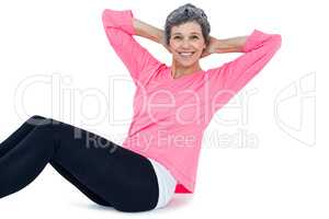 Portrait of mature woman doing sit ups