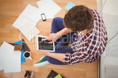 Creative businessman working on digital tablet in office