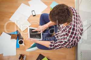 Creative businessman working on digital tablet in office