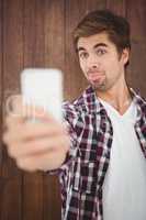 Hipster making face while taking selfie