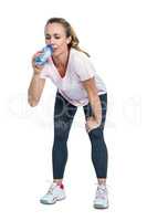 Tired woman bending and drinking water