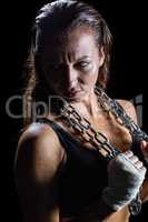 Annoyed female athlete holding chain