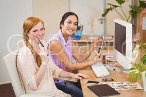 Businesswomen using tablet PC at desk