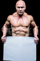 Portrait of shirtless man holding blank paper