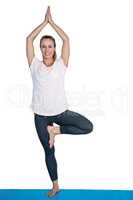 Portrait of happy fit woman in tree pose