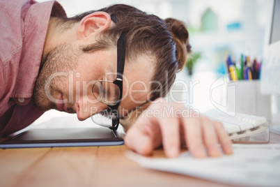 Businessman resting with head on desk Businessman resting with head on desk