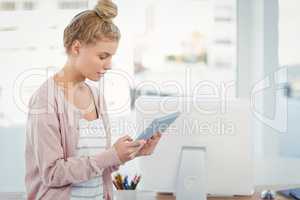 Woman using digital tablet in office