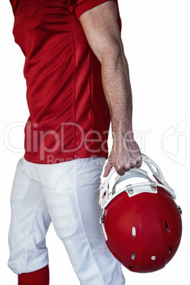 Midsection of rugby player holding the helmet