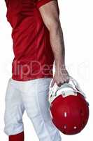 Midsection of rugby player holding the helmet