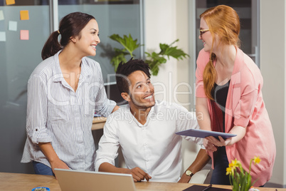 Happy business people at desk